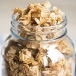 A close up of simple granola filled to the brim of a large mason jar.