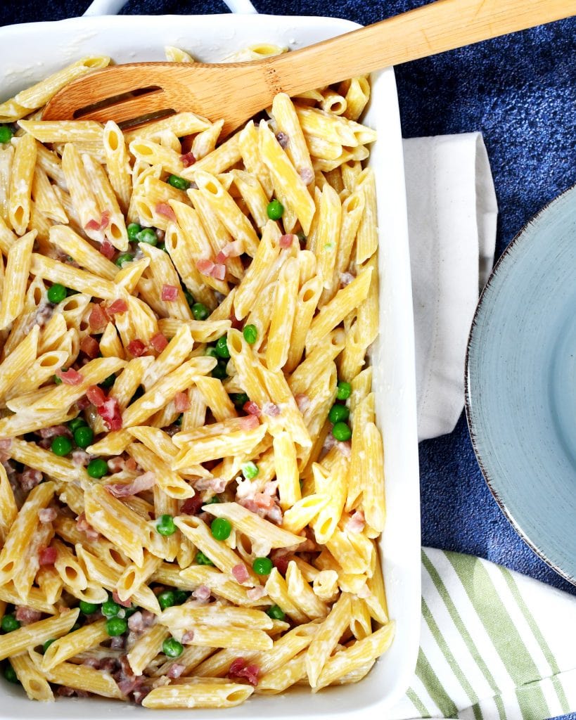 Top view of pasta panna prosciutto in a white baking pan.
