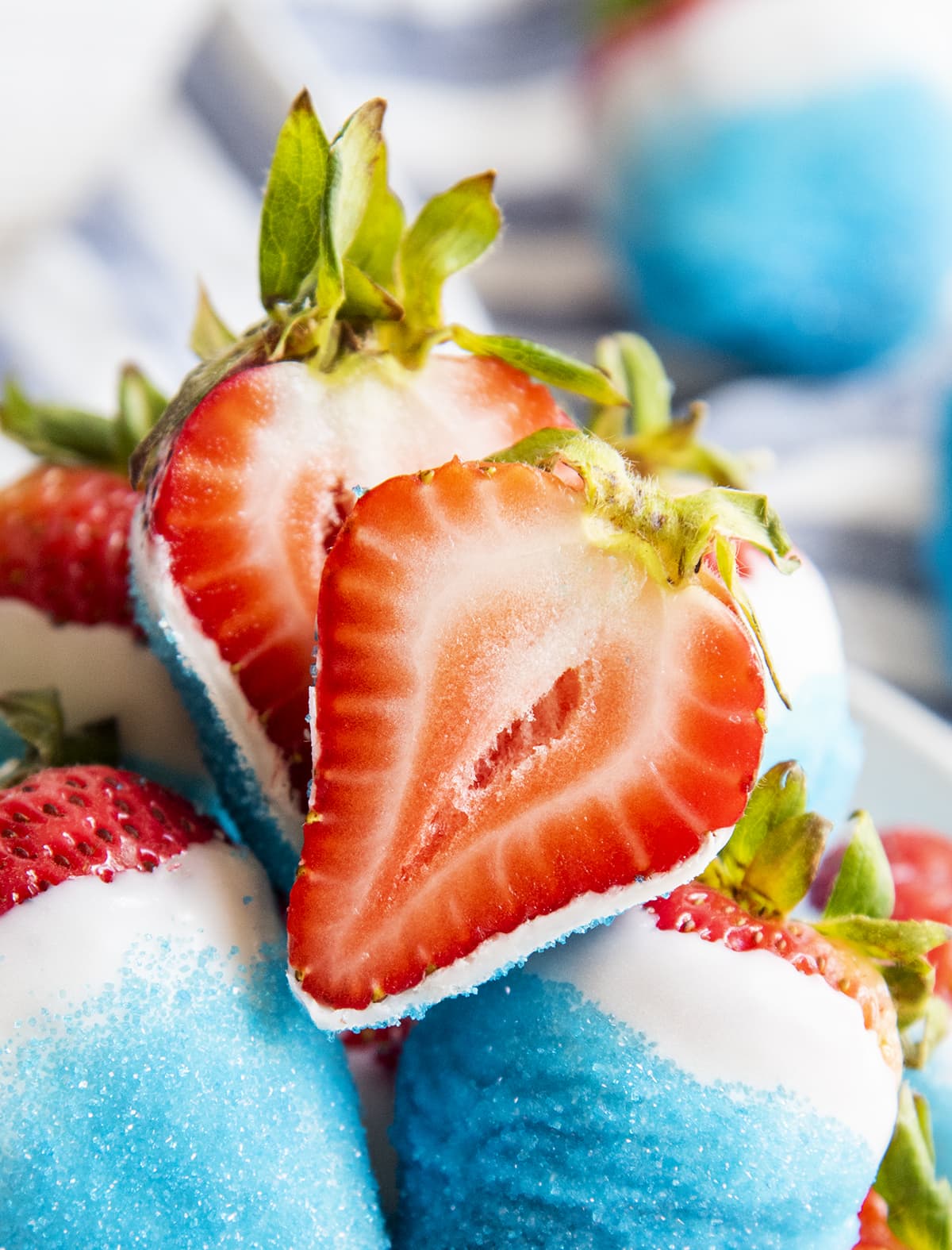 A red white and blue strawberry cut open showing the middle of the strawberry.
