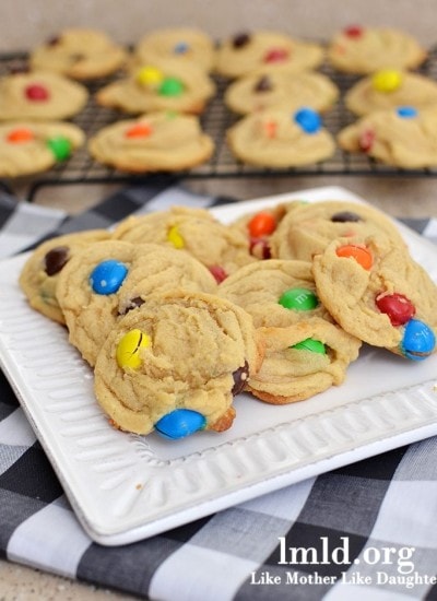 Angled view of peanut butter M&M cookies on a white plate.