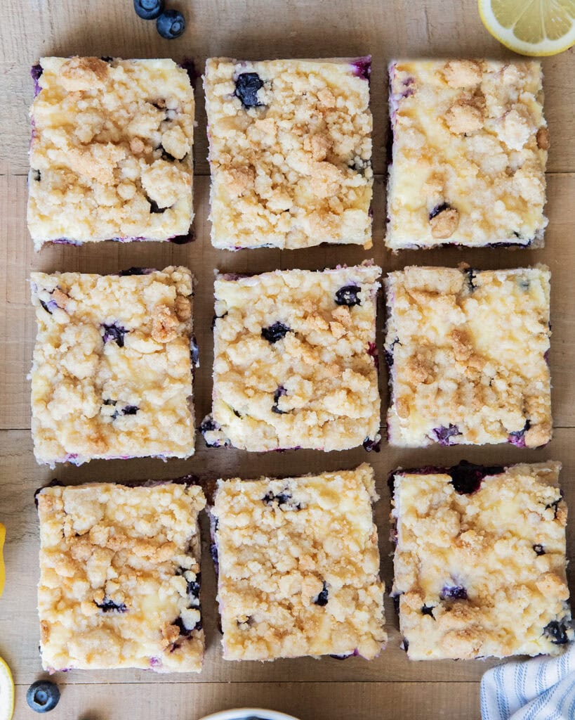 An above view of cheesecake bars with crumb topping on top.