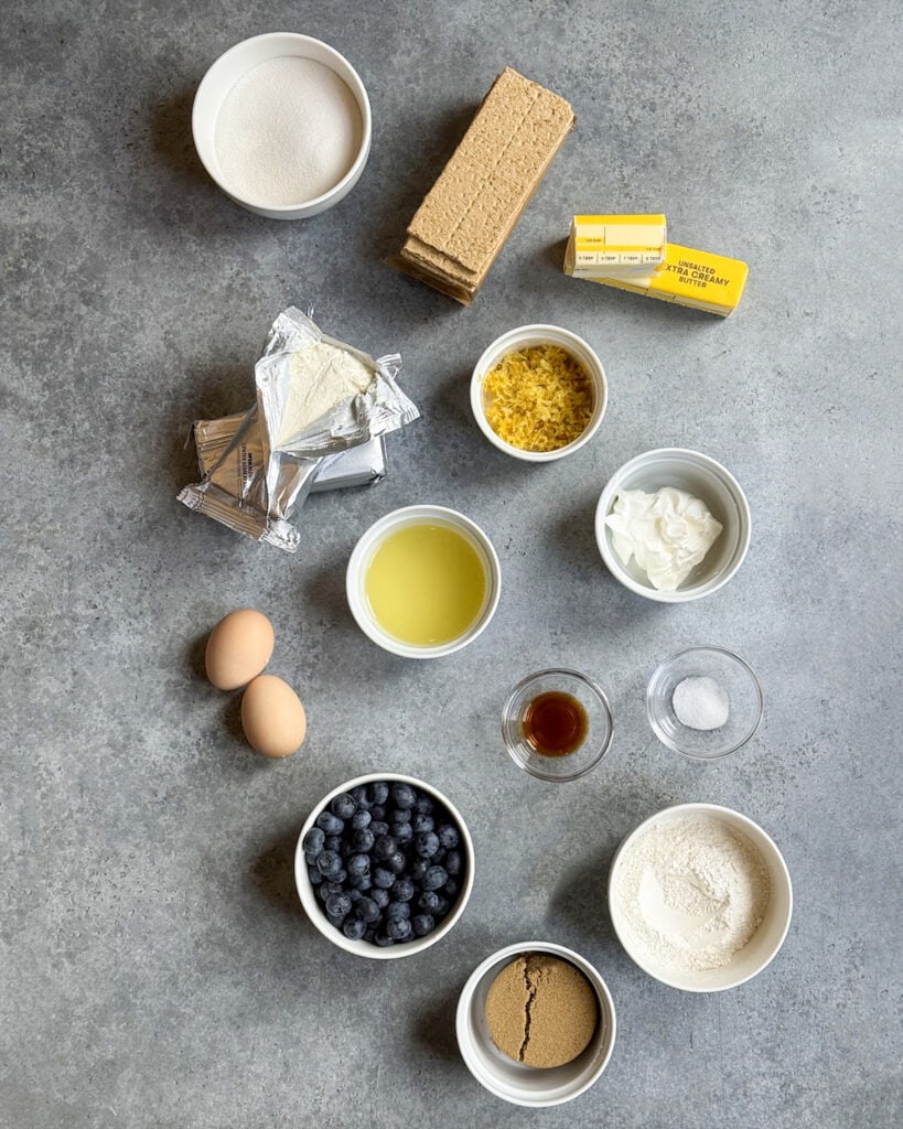 Bowls of the ingredients needed to make blueberry lemon cheesecake bars. 