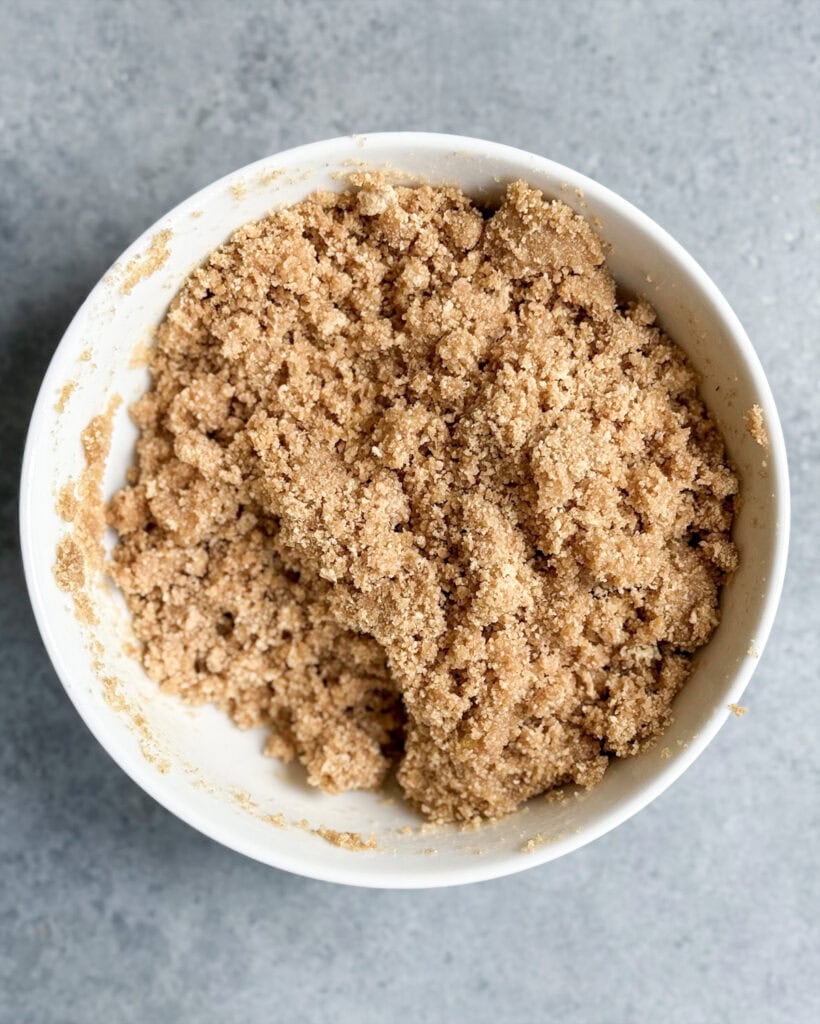 A crumbly graham cracker crust mixture in a bowl. 