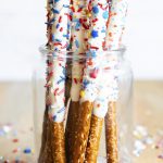 Fourth of July White Chocolate Pretzels dipped in white chocolate and topped with sprinkles.