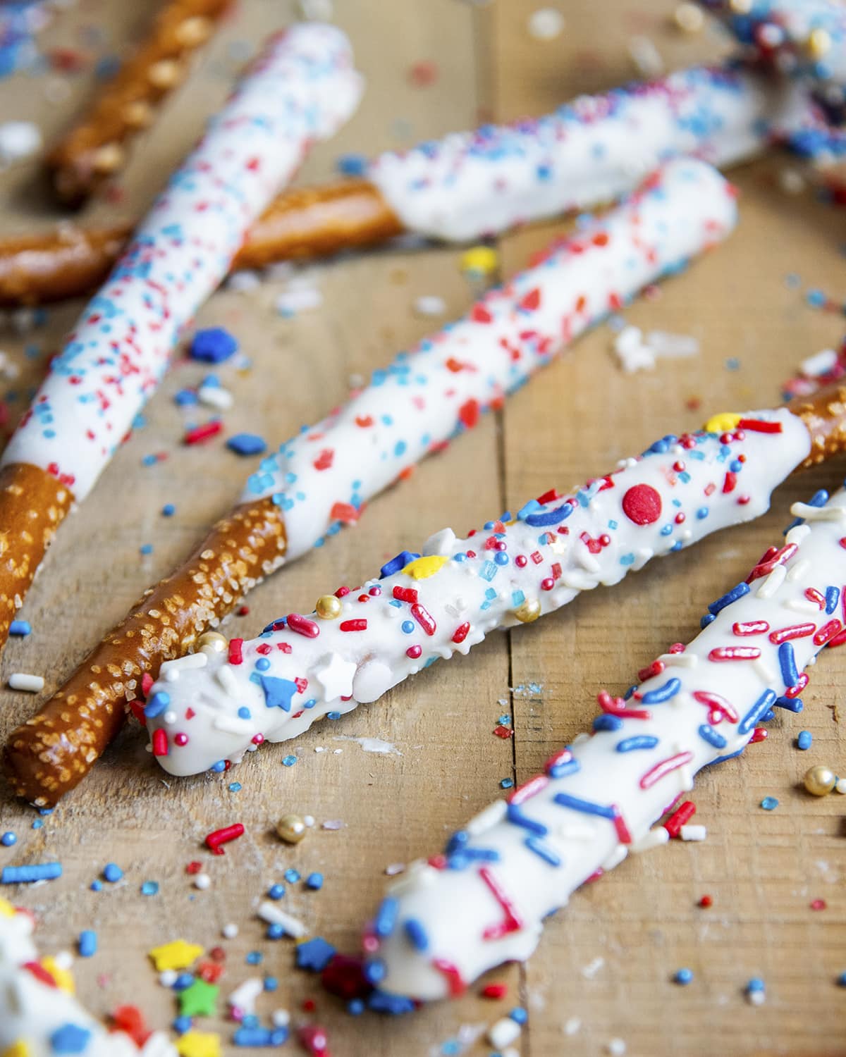 Pretzels dipped in white chocolate and topped with red, white, and blue, sprinkles.