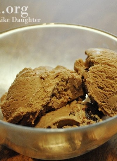 Angled view of chocolate almond cherry ice cream in a glass bowl.