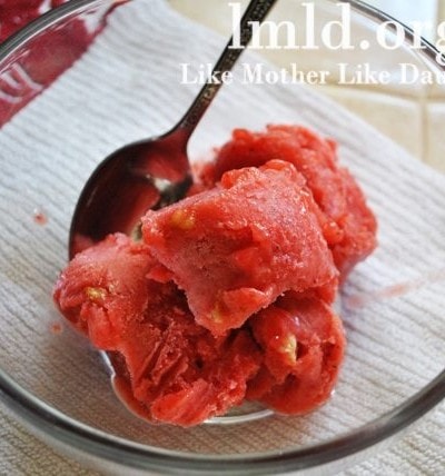 Top view of strawberry orange sorbet in a glass bowl.