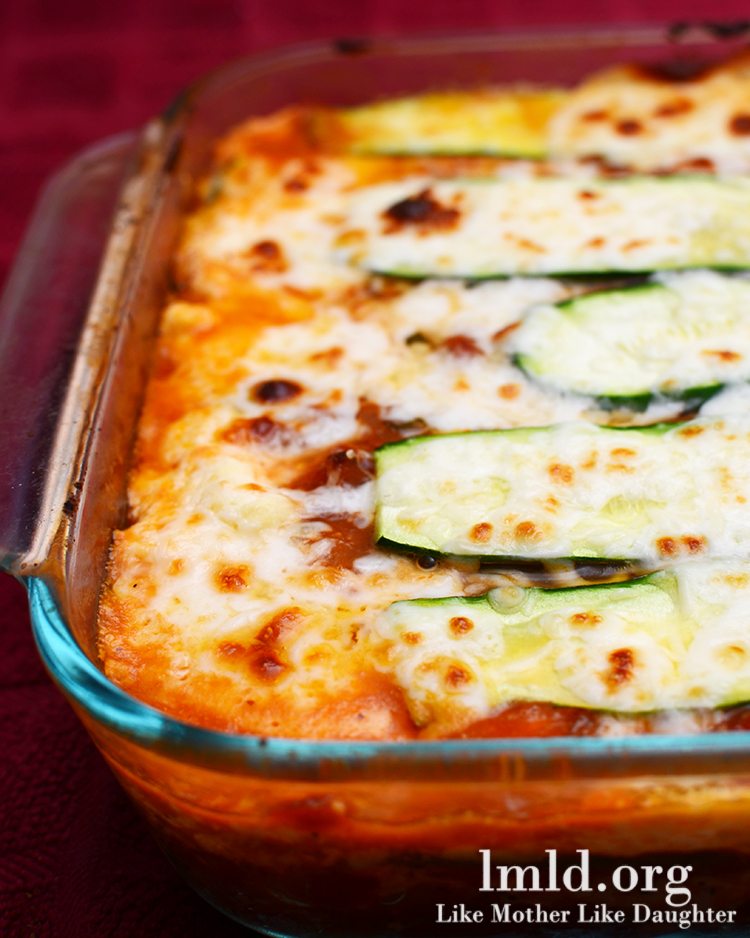 A glass baking tray of cheesy zucchini lasagna. 