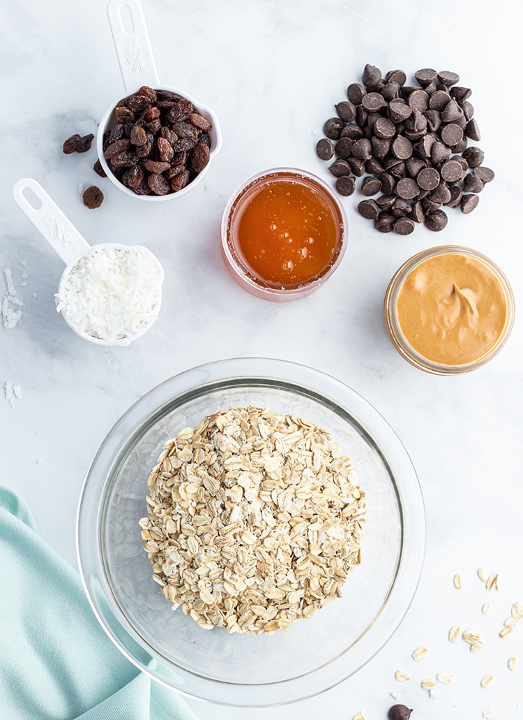 An above shot of no bake granola bar bites ingredients with chocolate, honey, and peanut butter.