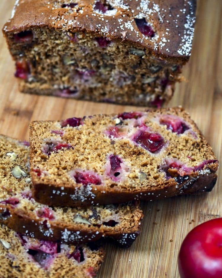 Slices of sweet bread filled with pieces of plums and pecans.