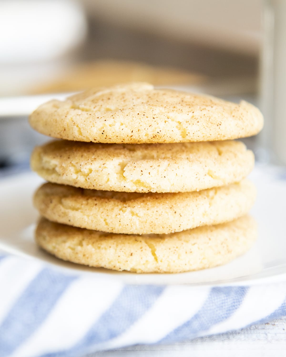 A close up photo of a stack of 4 snickerdoodle cookies.