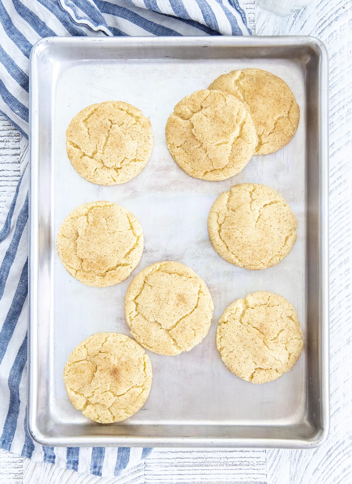 A baking pan with snickerdoodle cookies on it.