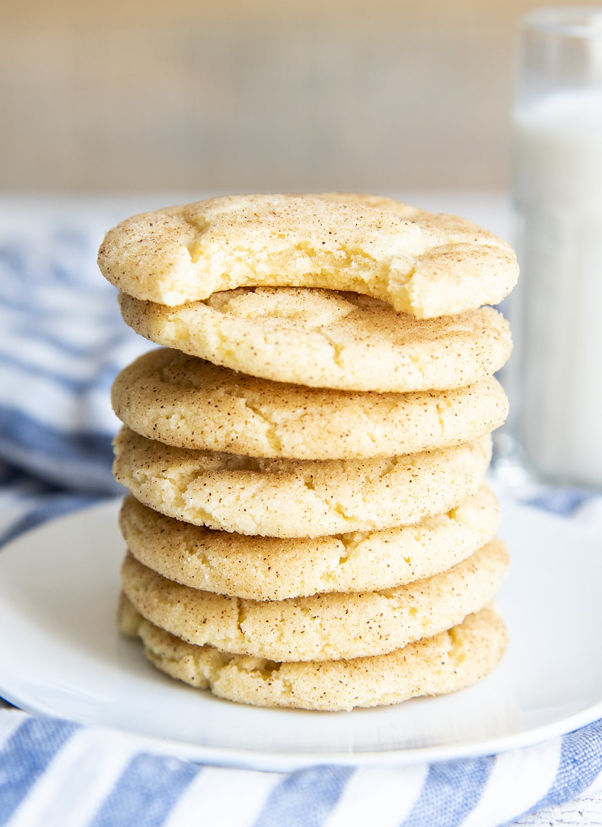 A stack of snickerdoodles. The top cookie has a bite out of it.
