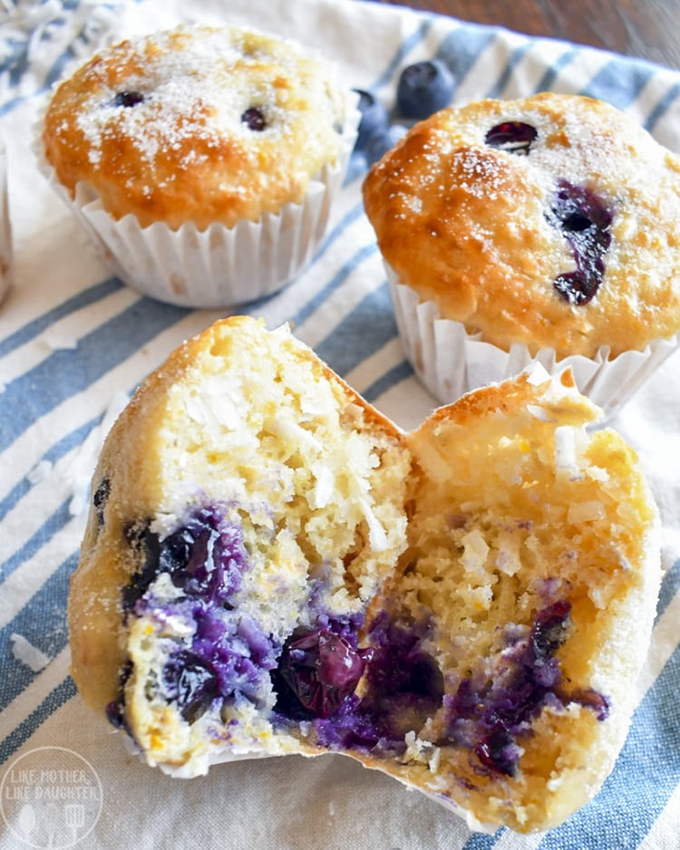 A blueberry coconut muffin cut in half showing the juicy blueberry middle. 