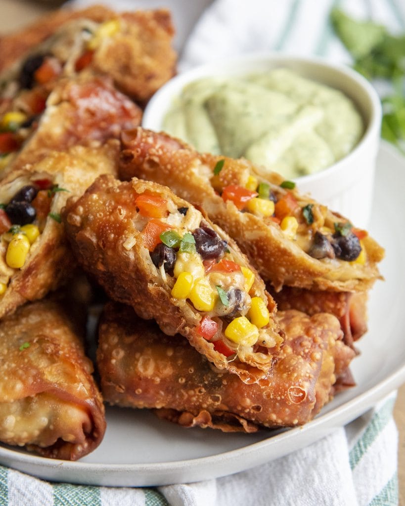 A pile of southwest chicken rolls on a plate.