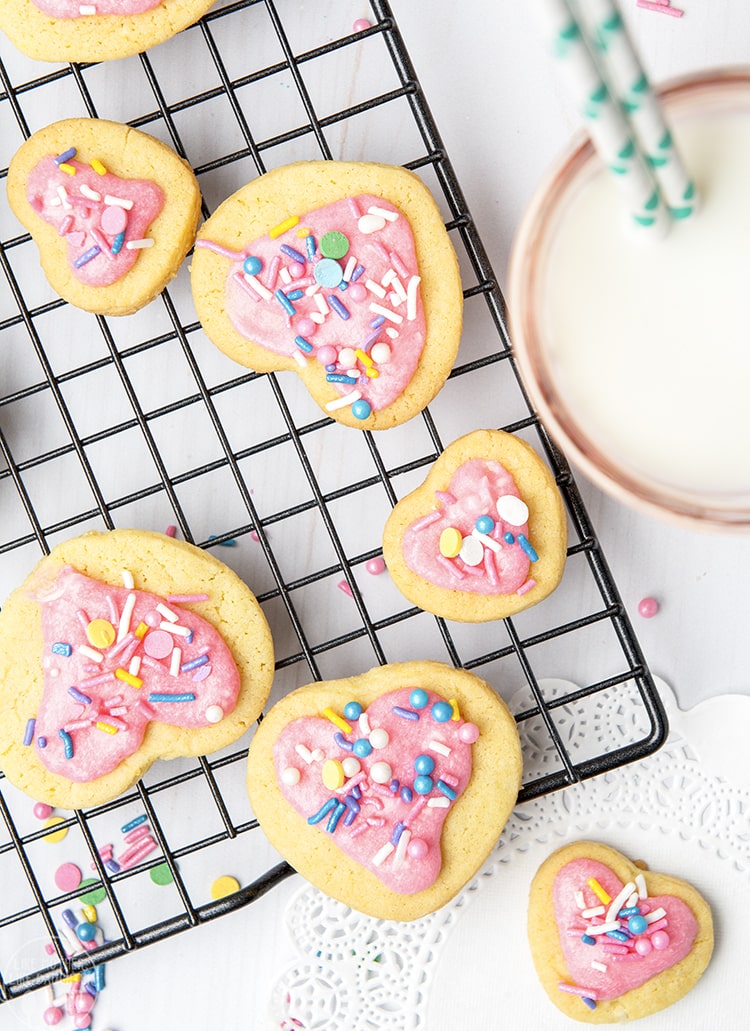 Above shot of sugar cookies for two with multiple cookies on a cooling rack with sprinkles.