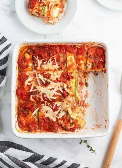 A plate of food with a slice of pizza, with Cheese and Zucchini lasagna