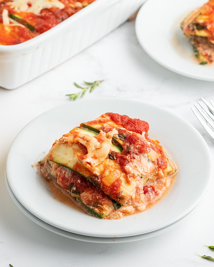 A plate of zucchini lasagna, showing the layered zucchini, red sauce and cheese.