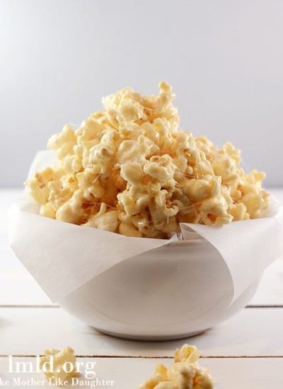 Front view of marshmallow caramel popcorn in a white bowl.