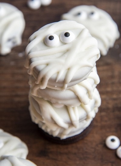 A stack of Oreos dipped in white chocolate to look like mummies.