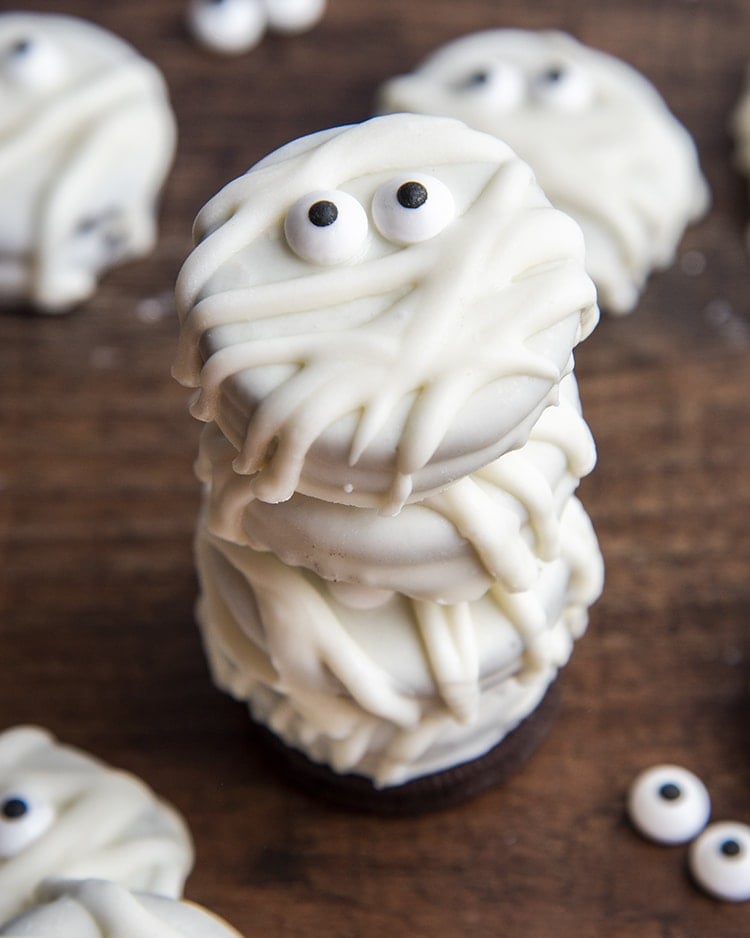 A stack of Oreos dipped in white chocolate to look like mummies.