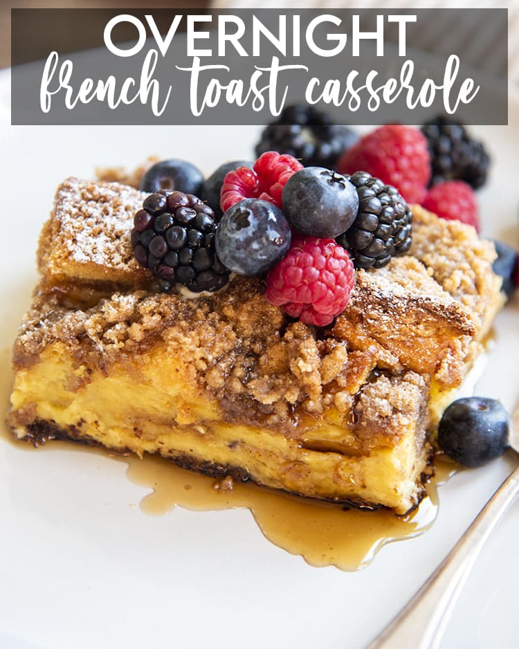 A piece of french toast casserole topped with fresh berries. There is a text overlay over the top of the photo for pinterest. 