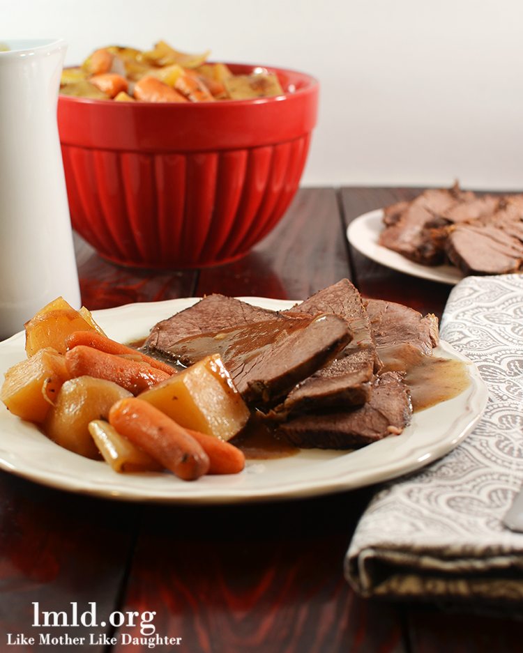 Front view of tavern style crock pot beef roast on a white plate.