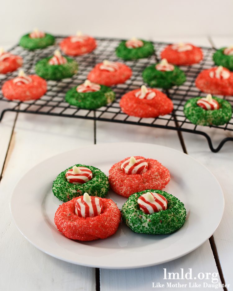 Angled view of candy cane blossoms on a cooling rack and white plate.