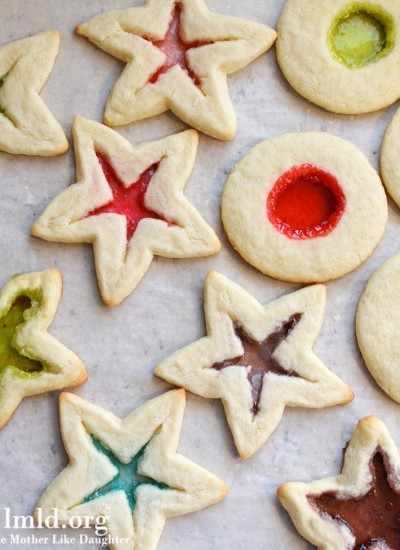 Top view of stained glass window cookies on parchment paper.