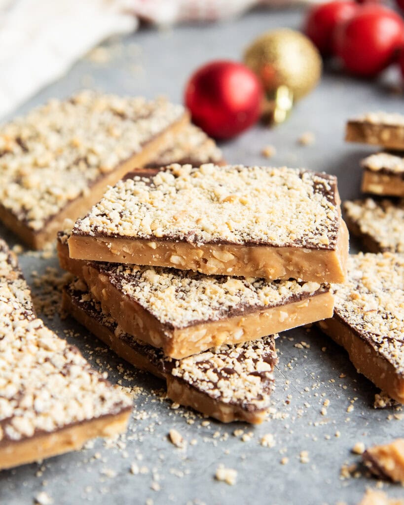 A pile of cashew toffee on a counter top.