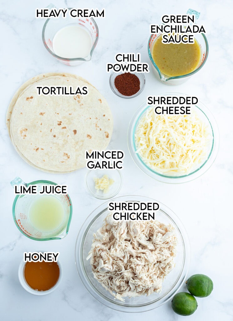 An above view of the ingredients needed to make honey lime chicken enchiladas; cream, enchilada sauce, cheese, honey, and lime juice.