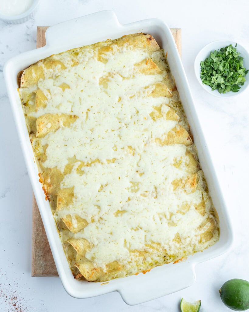 A pan of baked green enchiladas.