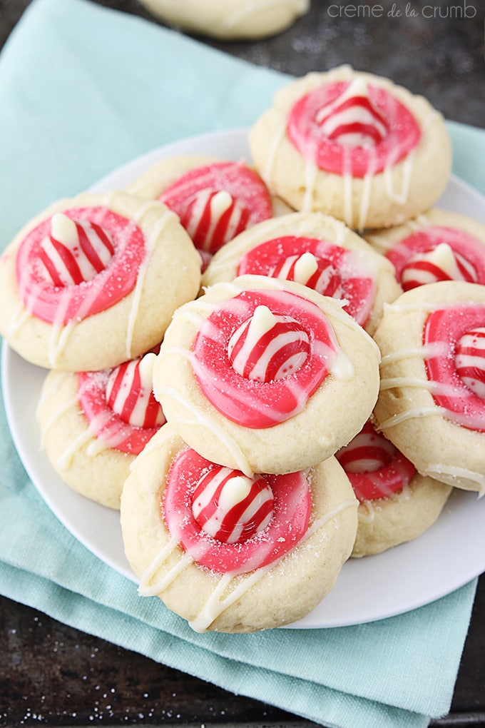 Top view of peppermint thumbprint cookies on a white plate.