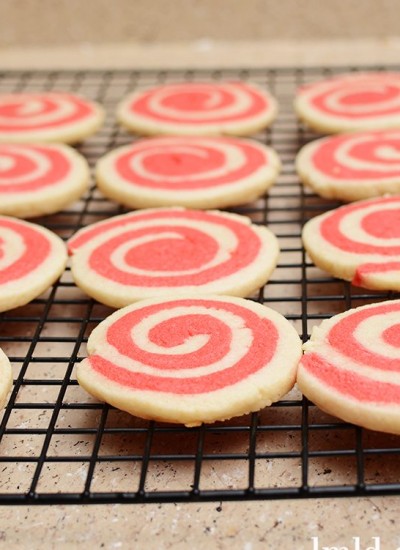 Front view of valentines pinwheel cookies on a cooling rack.