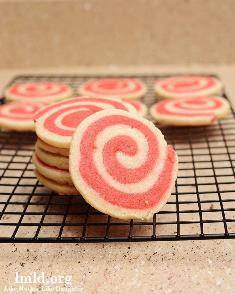Front view of valentines pinwheel cookies on a cooling rack.