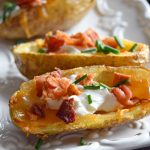 These crispy, cheese filled potato skins are a first-rate appetizer; top with bacon bits, sour cream, and chives. Enjoy them on your First Night Eve or any other time an appetizer is on the menu.