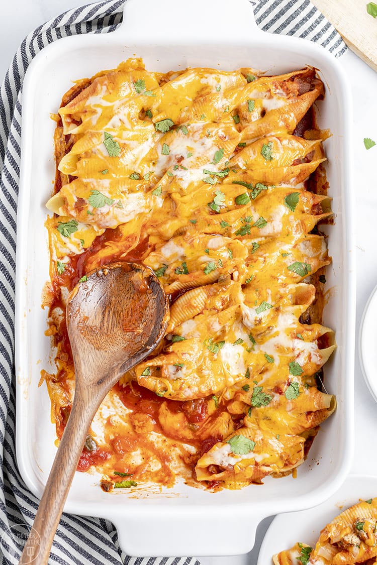 A pan of mexican stuffed shells is perfect for a weeknight dinner