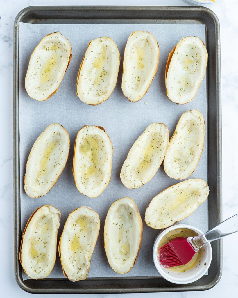 Half of potatoes with inside scooped out and topped with seasoned butter. 