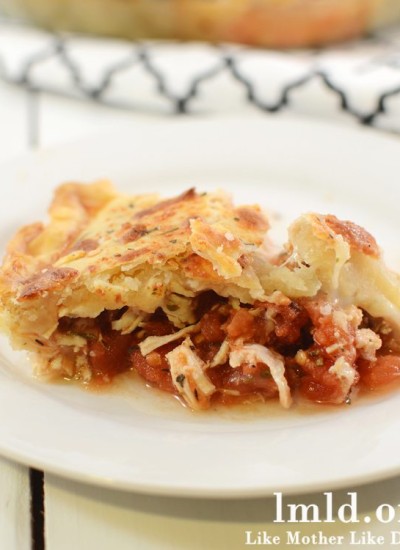 Front view of chicken parmesan pot pie on a white plate.