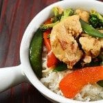 Close up view of chicken stir fry in a white bowl.