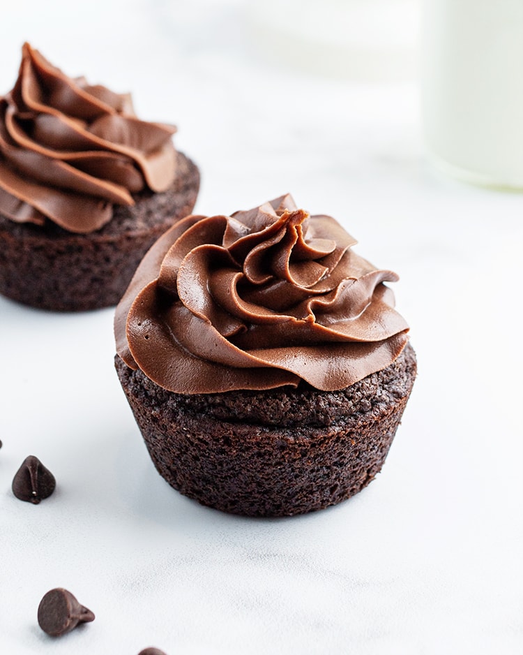 A chocolate cupcake topped with a creamy, rich chocolate frosting.