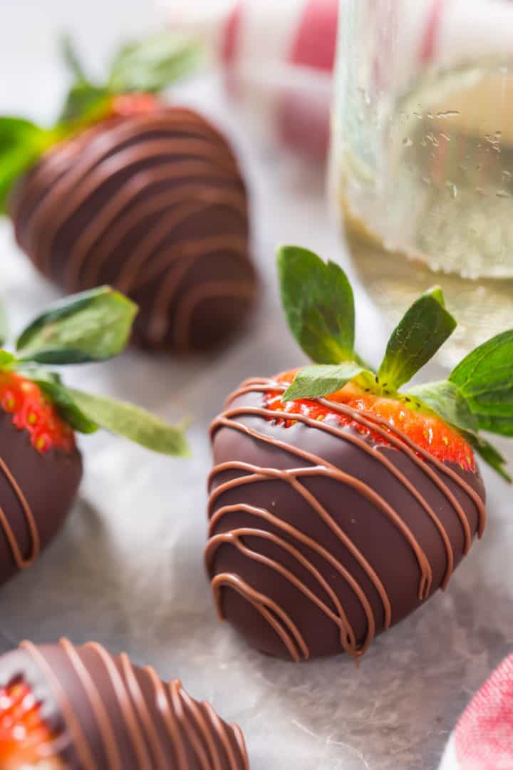 Close up image of the best chocolate for chocolate covered strawberries on a plate.