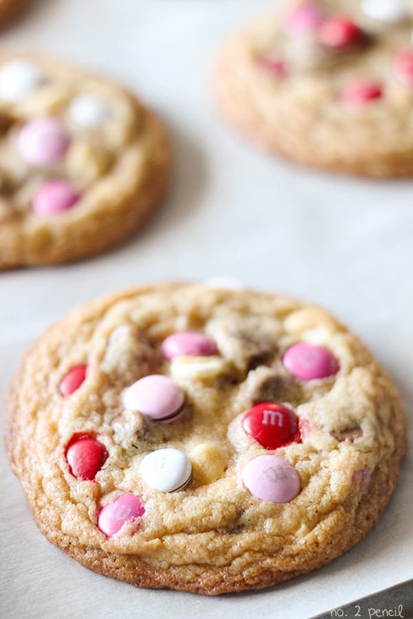 Close-up image of perfect m&m cookies with pink candies on top.