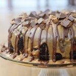 Chocolate peanut butter bundt cake on a glass cake stand.