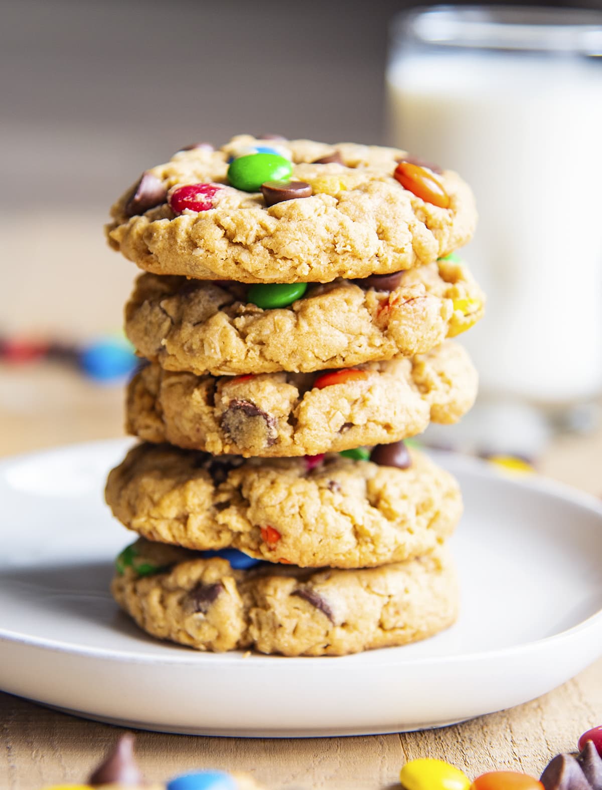 A stack of peanut butter monster cookies on a white plate.