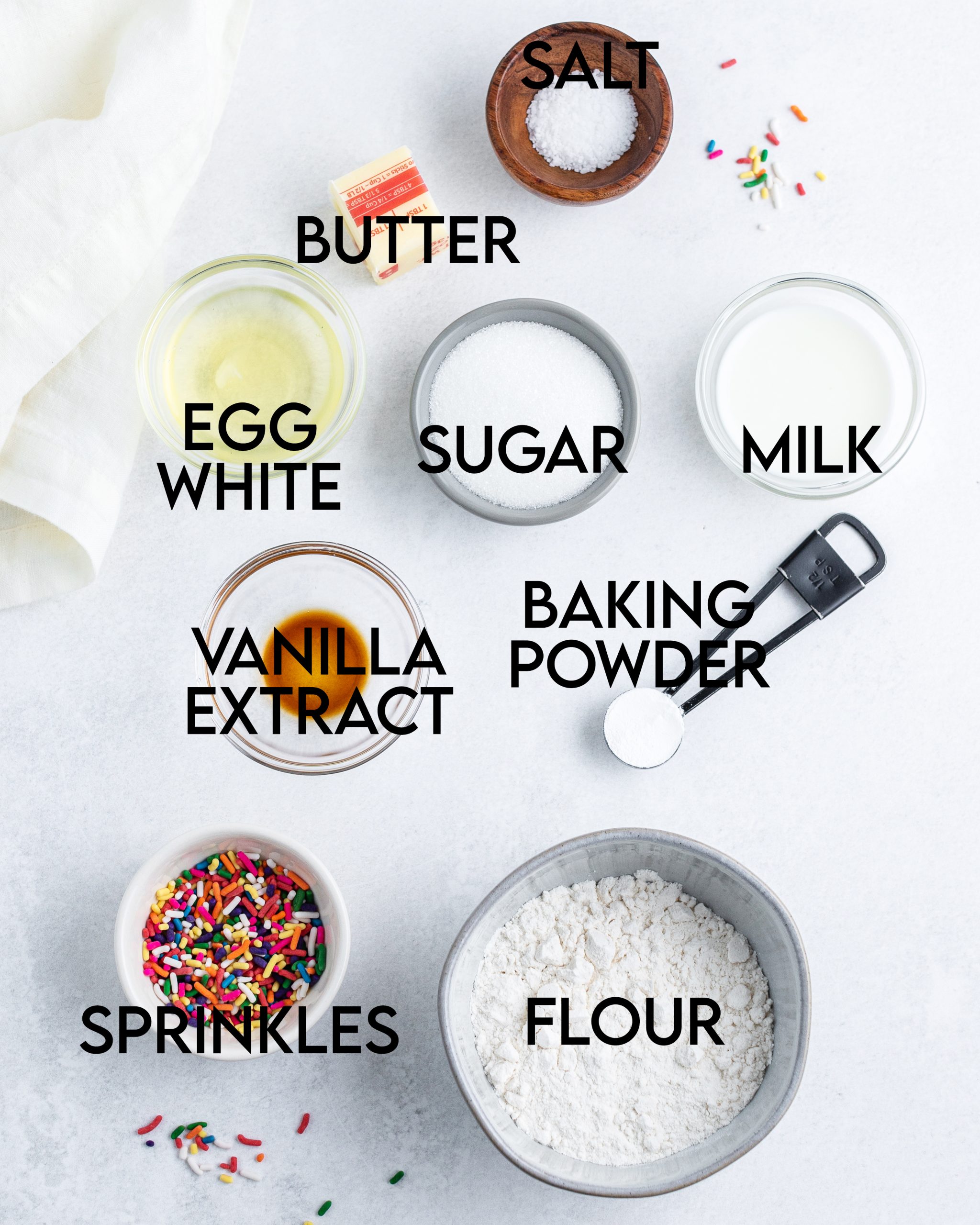 Labeled ingredients needed to make funfetti cupcakes.