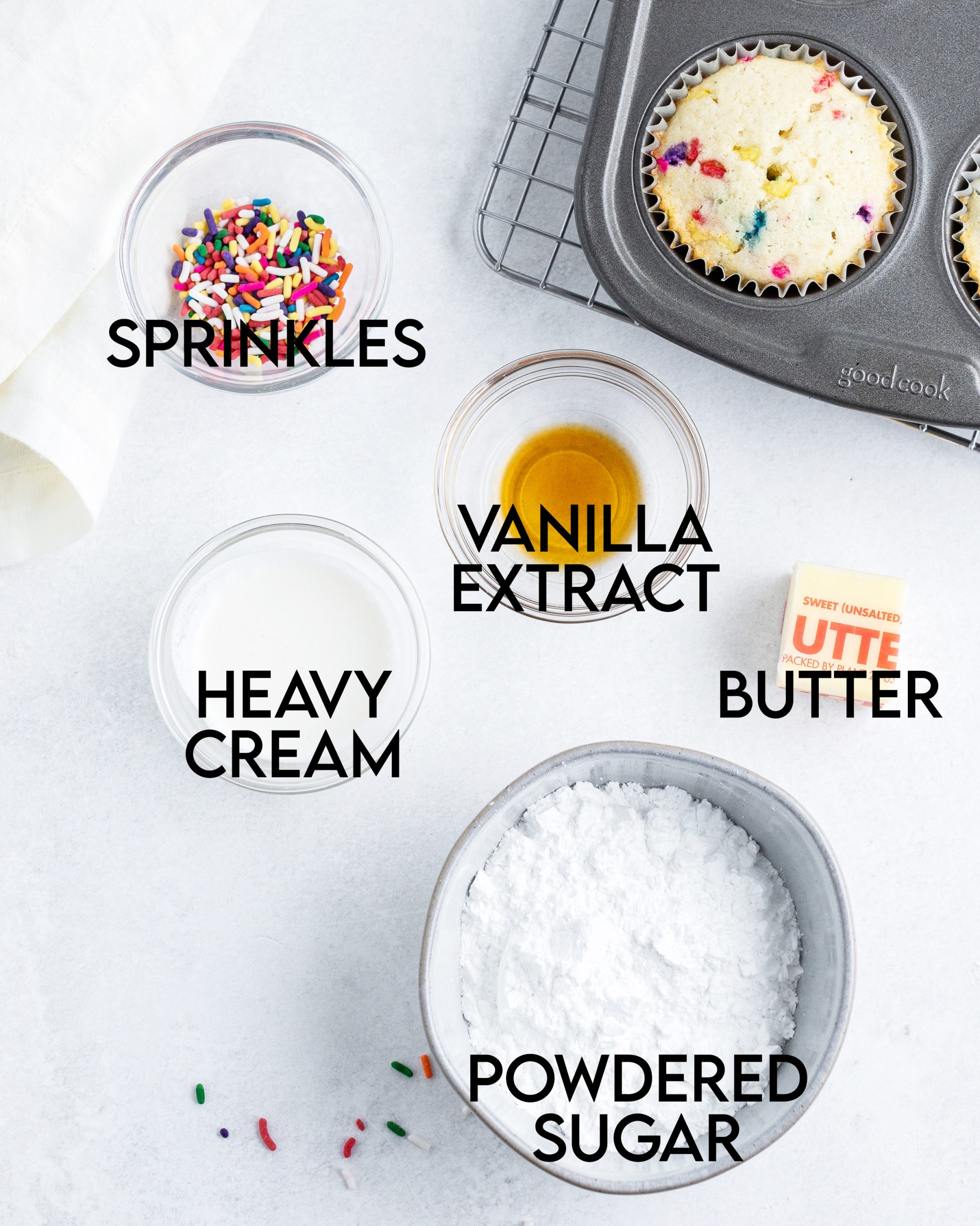 Ingredients needed to make a buttercream frosting with sprinkles.