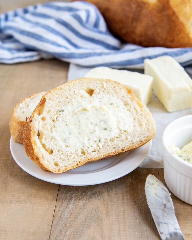 A slice of bread spread with garlic butter.