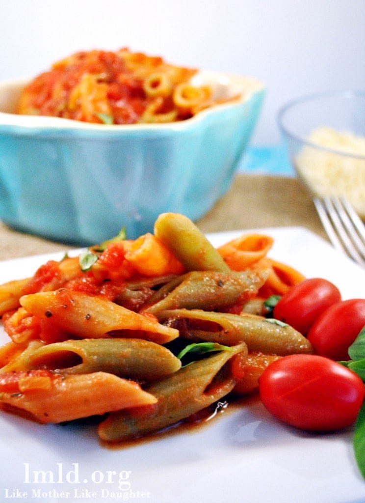 tomato basil penne pasta Front view of tomato basil penne pasta on a white plate.