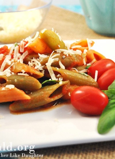Front view of tomato basil penne pasta on a white plate.